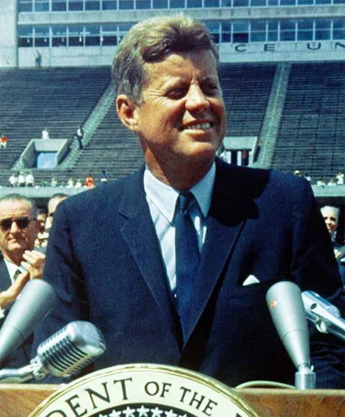 John F. Kennedy standing at a podium, giving a speech